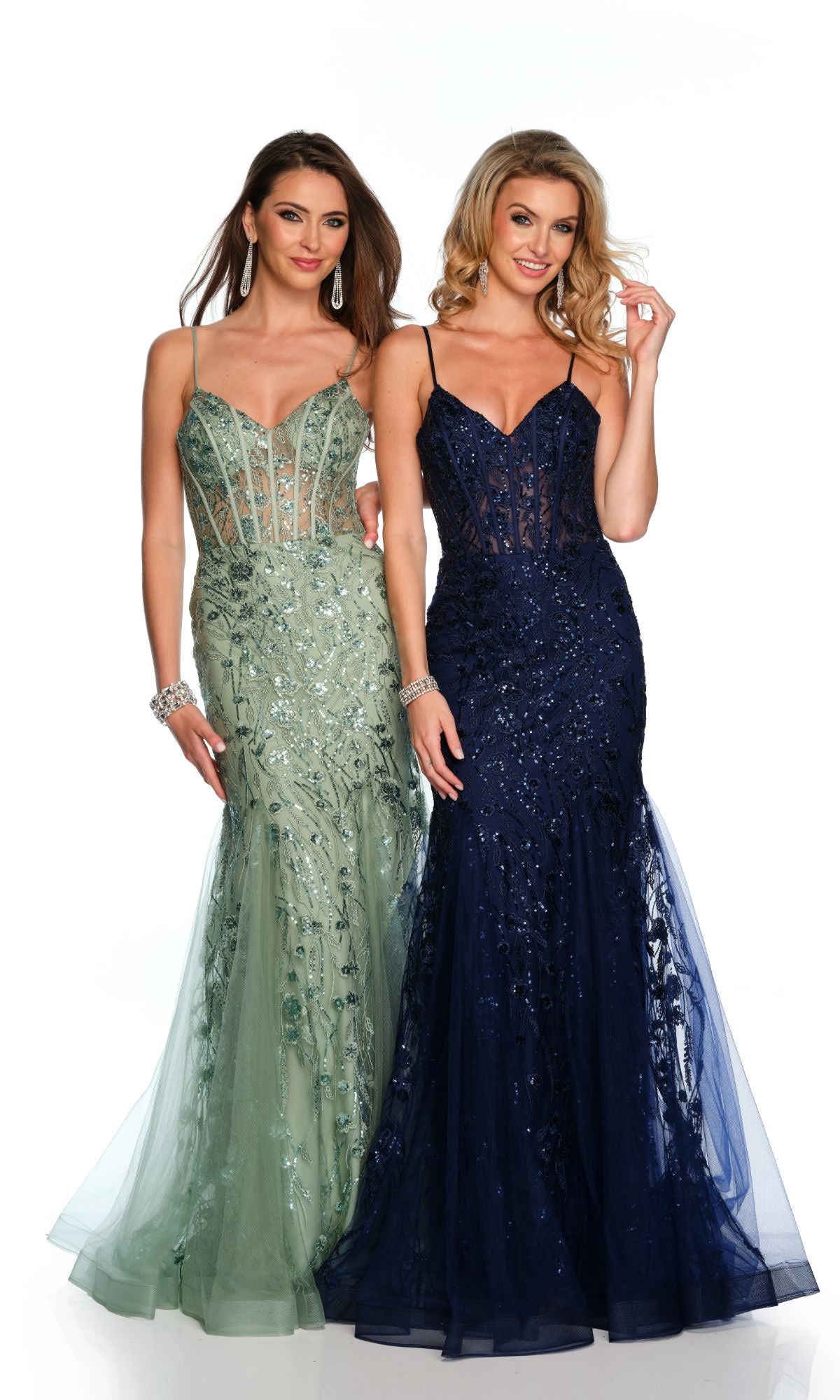 Two women stand smiling in Dave & Johnny Long Prom Dress 11658—one in sage green and one in navy blue. Both dresses are floor-length, fitted, with thin straps, sheer embroidered bodices, and a v-neckline.